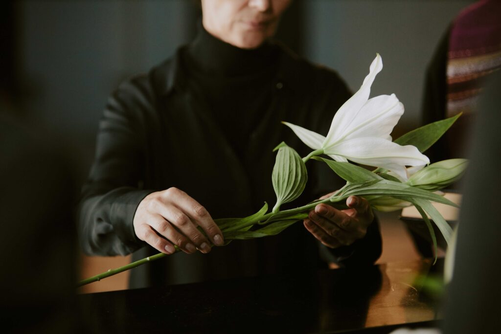 A woman laying down a flower during a celebration of life