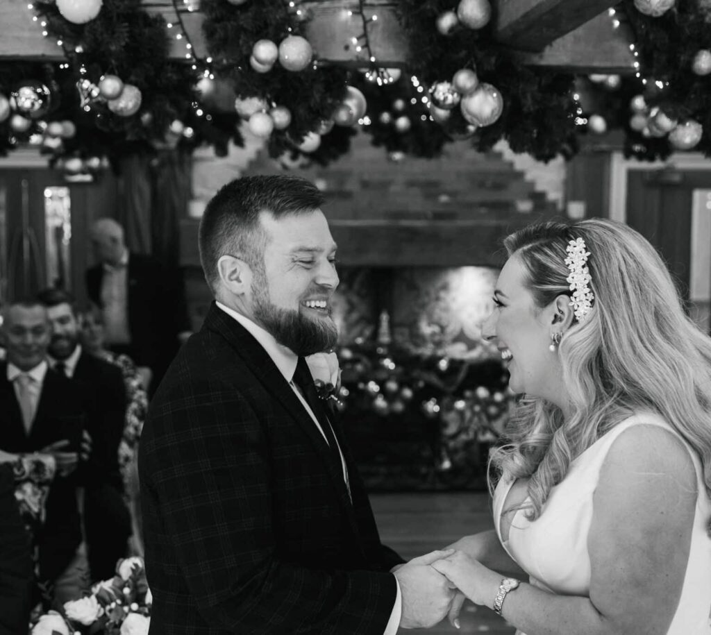 Two people smiling at each other during their wedding