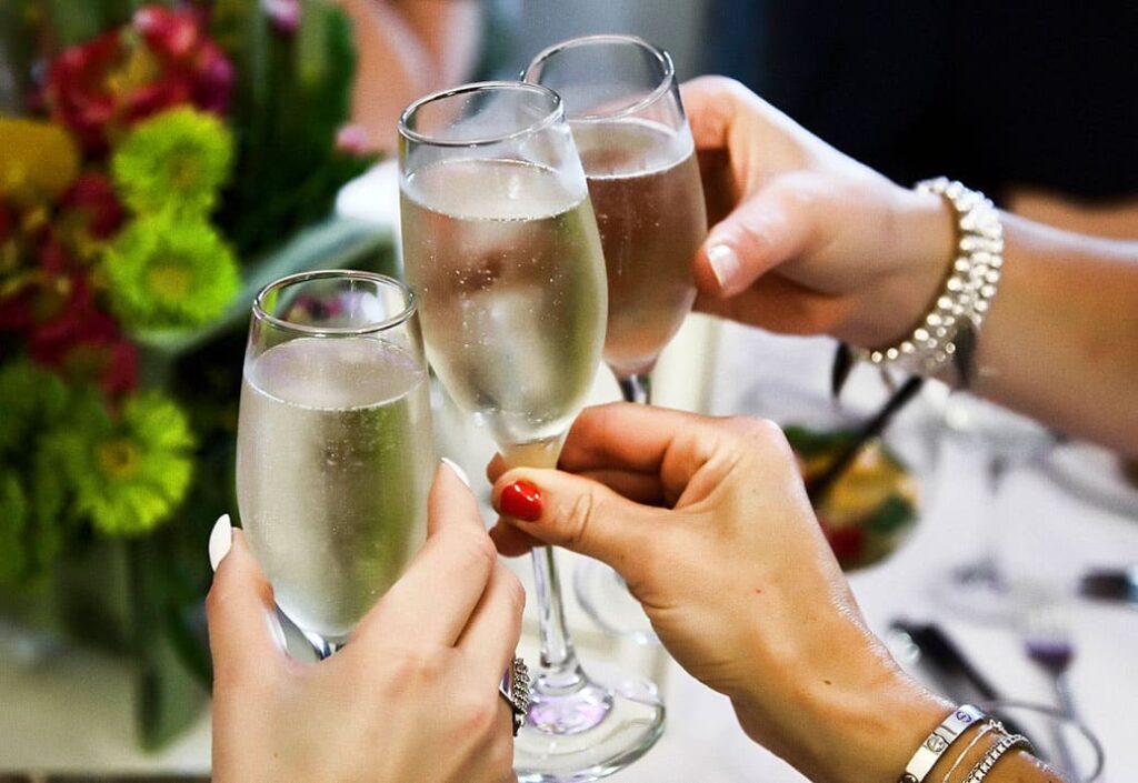 Women cheering with champagne glasses